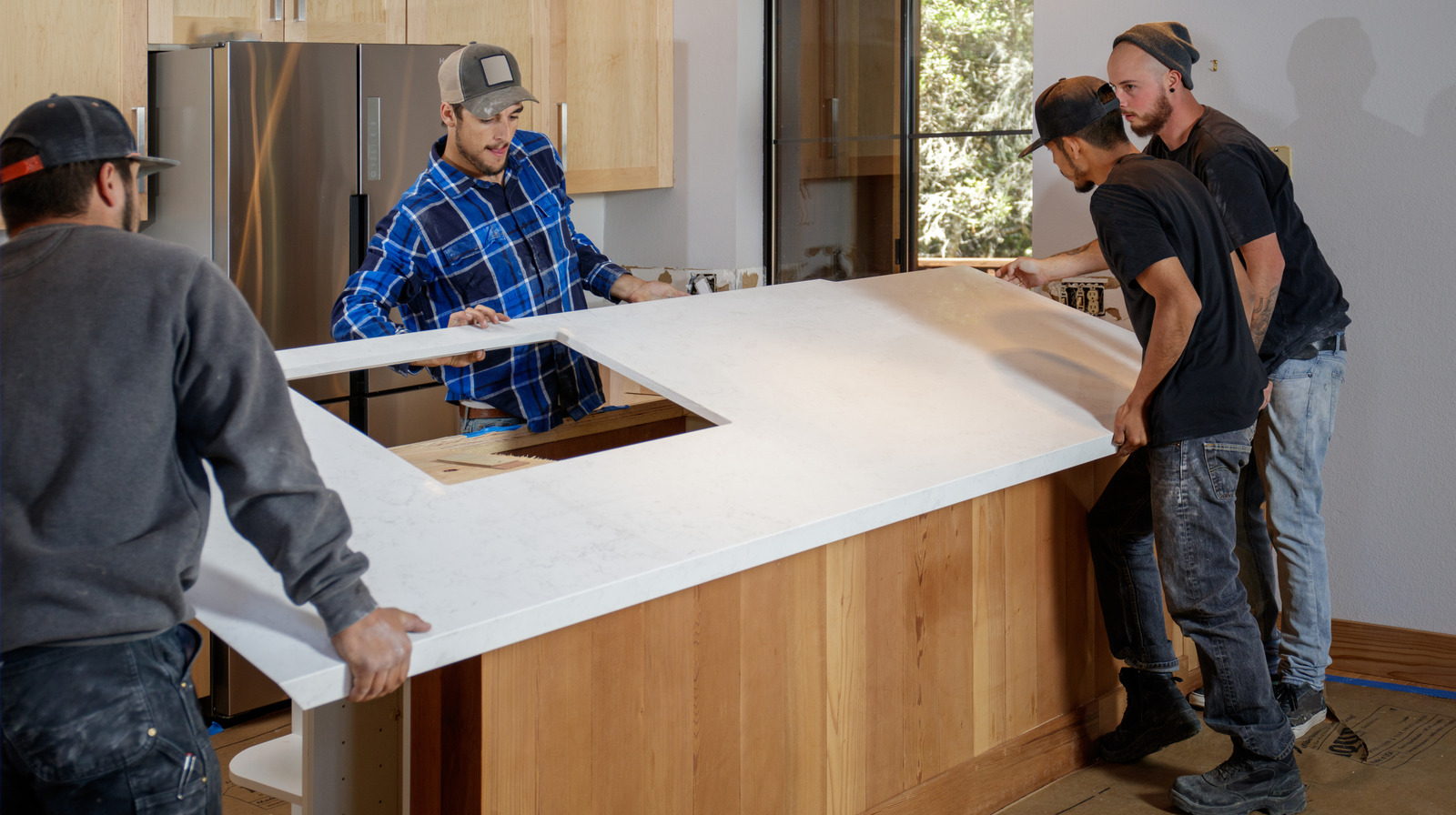 Kitchen remodel - men installing quartz countertops