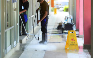 Man cleaning the floor with cleaning tool.
